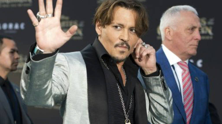Johnny Depp, ex-managers settle financial lawsuit