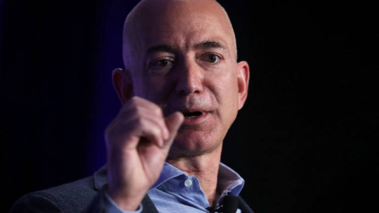 Bezos says he is not cowed by Trump
