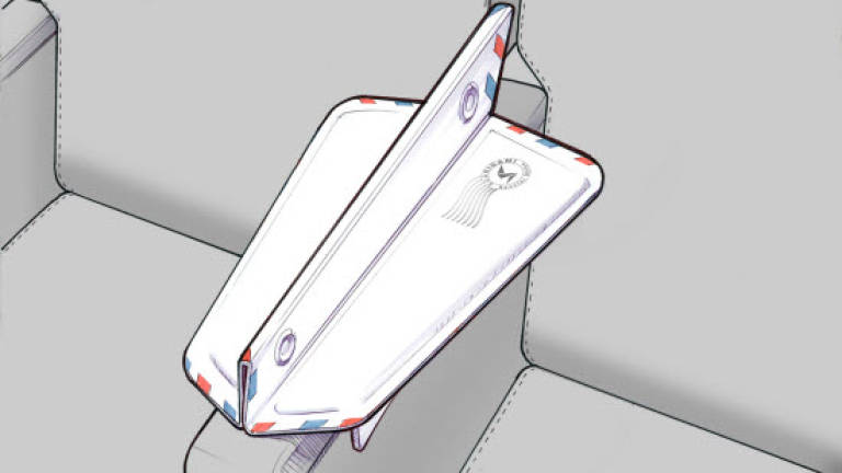 Fold-out gadget can double in-flight armrest space