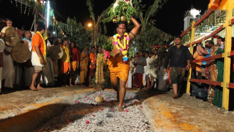 Hindu devotees take part in fire-walking ceremony in Air Itam