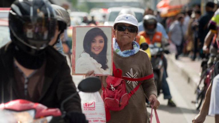 Thai ex-PM Yingluck skips court, arrest warrant issued