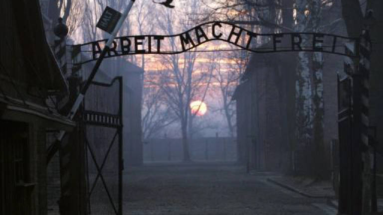 Poland charges 11 over bizarre Auschwitz stunt