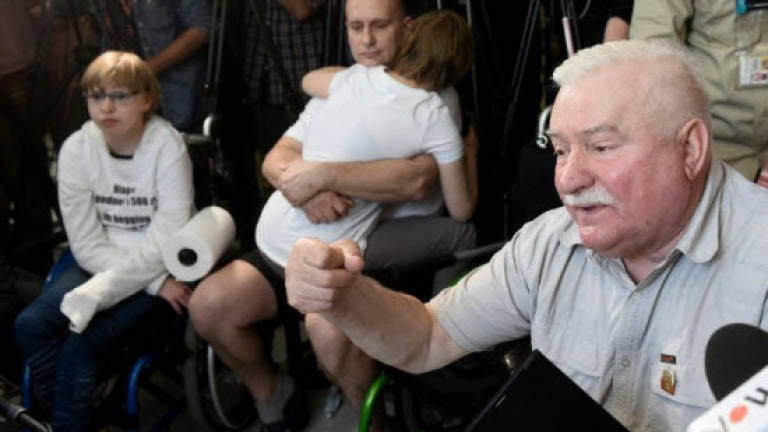 Poland's freedom icon Walesa backs disabled protesters