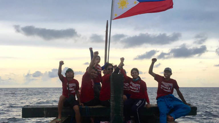 Philippine protesters say harassed by Chinese during flag stunt