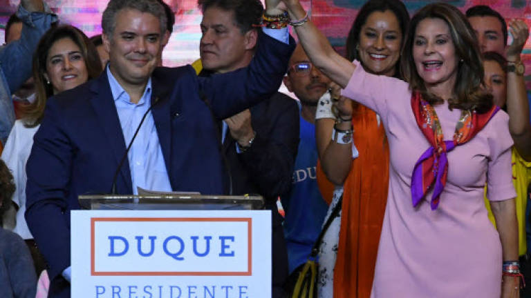 Anti-FARC conservative wins as Colombia presidential vote faces runoff