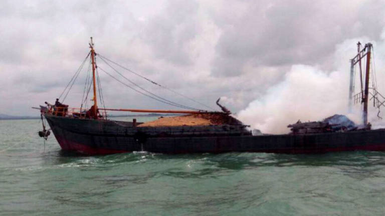 Seven Indonesians rescued from blazing barter trade ship