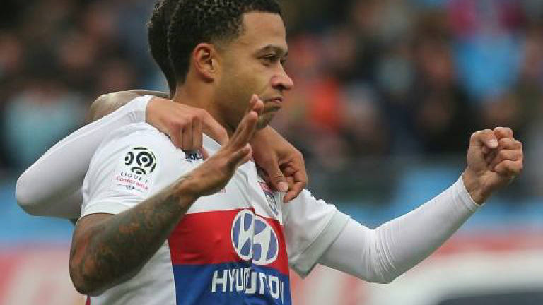 Depay hits hat-trick in Lyon romp