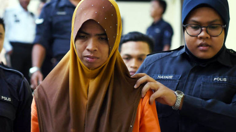 Woman who slashed son to death charged in court