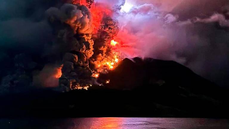 This handout photograph taken and released by the Center for Volcanology and Geological Hazard Mitigation on April 17, 2024, shows Mount Ruang spewing hot lava//AFPix