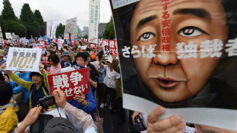 Tens of thousands protest at military bills outside Japan parliament