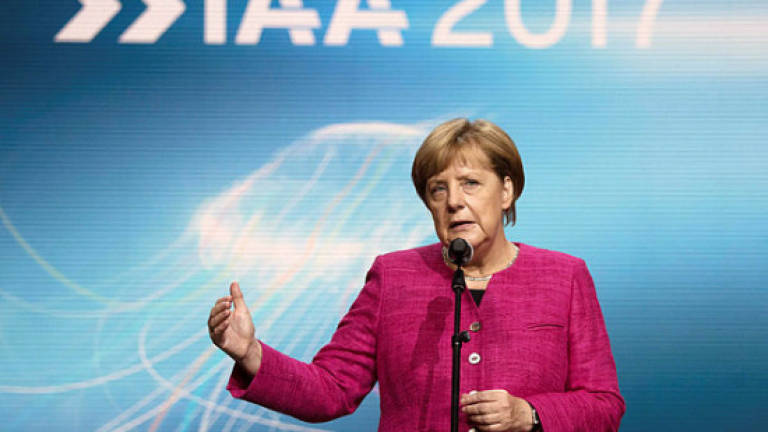 At Frankfurt auto show, Merkel urges car industry to restore trust