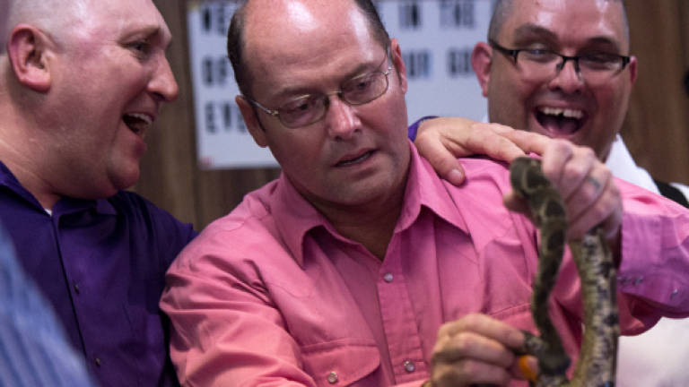 Snake-handlers of West Virginia test faith with poison Snake-handlers of West Virginia test faith with poison