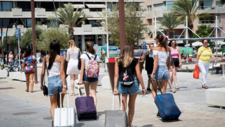 Packed with tourists, Ibiza struggles to house locals