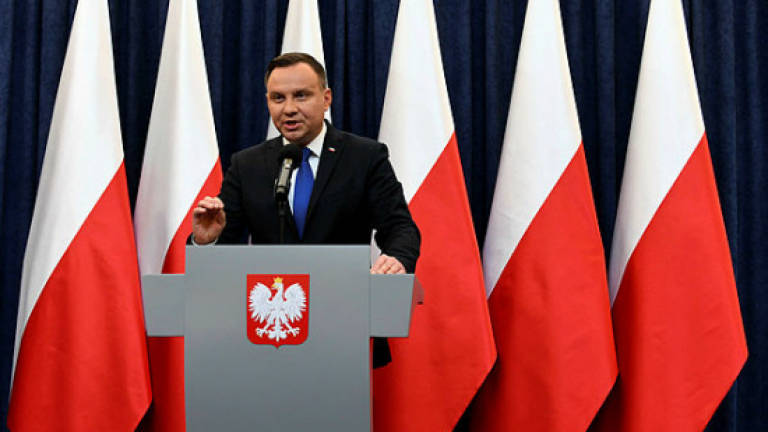 Poland's president signs controversial Holocaust bill into law