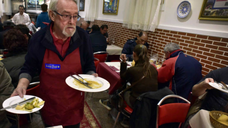 In Madrid, the homeless dine out ... for free