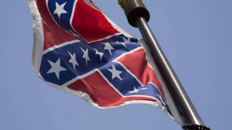 Woman pulls down Confederate flag at state house