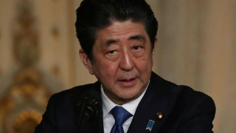 Japan's Abe welcomes N. Korea pledge, but defence chief vows pressure