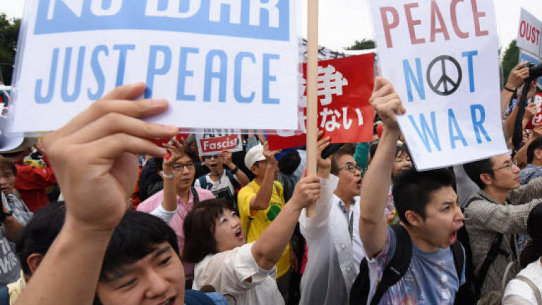 Tens of thousands protest at military bills outside Japan parliament