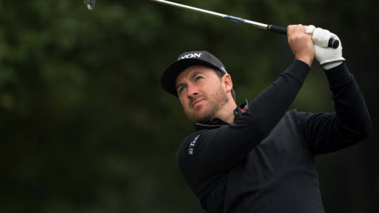 McDowell stays ahead as pack gathers at WGC-HSBC Champions