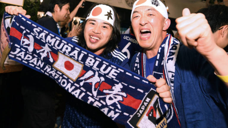 Japan put party on hold after making World Cup history