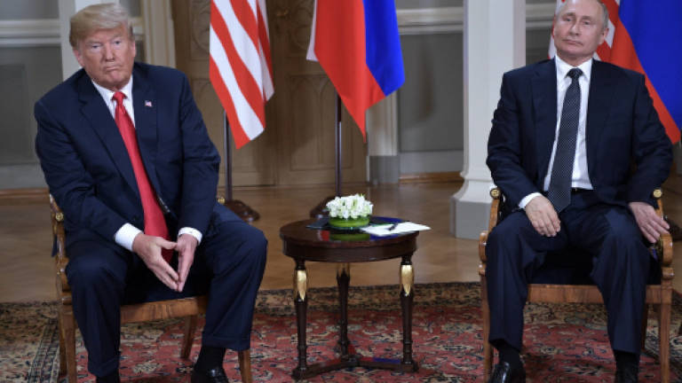 At summit, Trump refuses to confront Putin on vote row