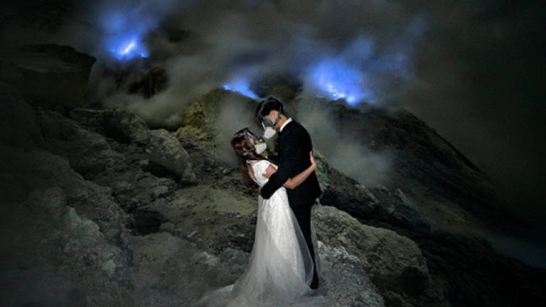 Malaysian couple take wedding photos inside active volcano