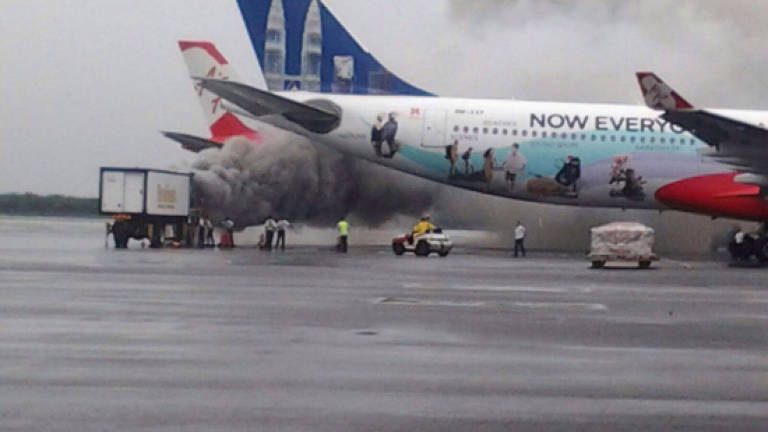 Food catering truck catches fire near AirAsia plane