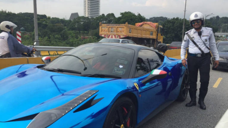 Stalled Ferrari causes traffic congestion along busy expressway