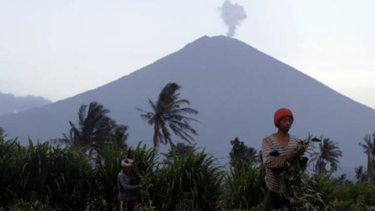 Authorities lower Bali volcano alert status