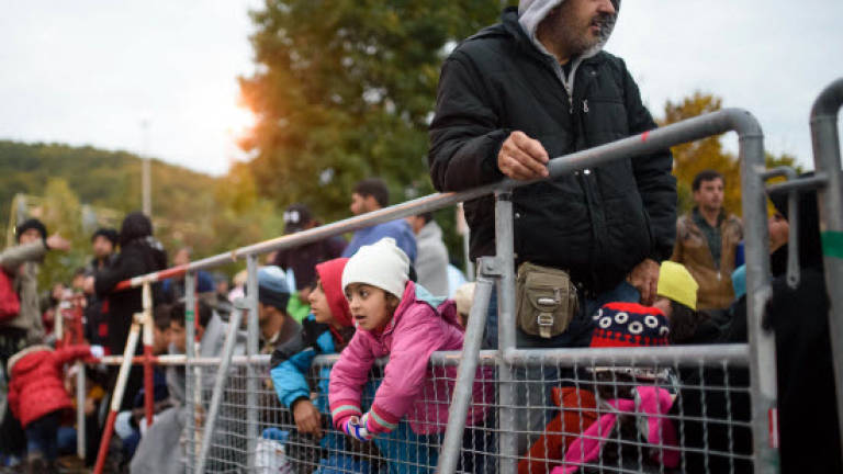 Slovenia buckles as migrants rush to escape winter, border closures
