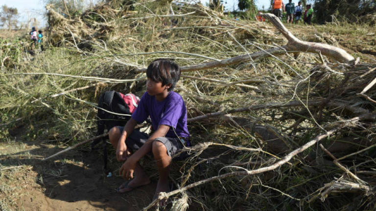 Typhoon survivors wait for aid in the Philippines
