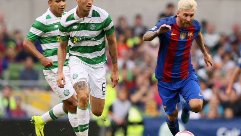 Messi quiet but Barcelona stroll past Celtic