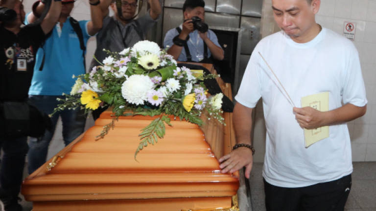 Swee Bok inconsolable as family laid to rest