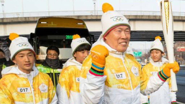 Olympic flame stops in Seoul on journey to Pyeongchang