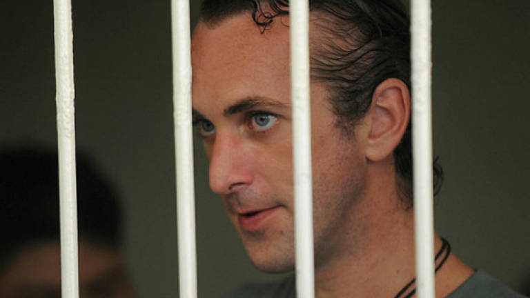 Australian, Briton jailed over brutal Bali cop killing