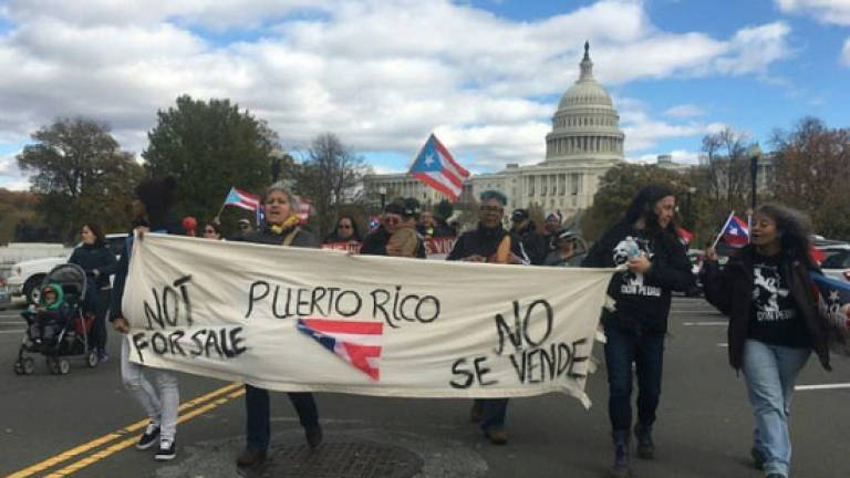 Protesters march in solidarity with hurricane-hit Puerto Rico