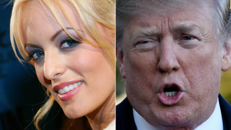 Porn actress says she was threatened to keep silent on Trump fling