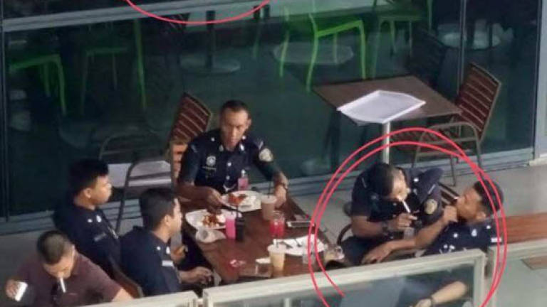 Picture of coppers smoking below no smoking sign goes viral