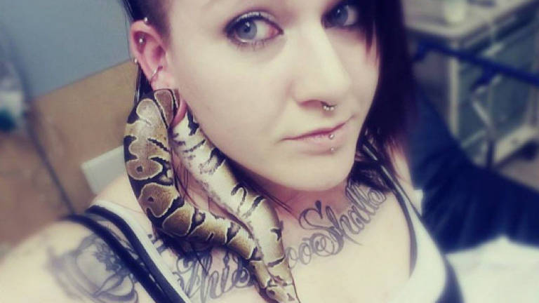 Pet snake gets stuck in teen's earlobe
