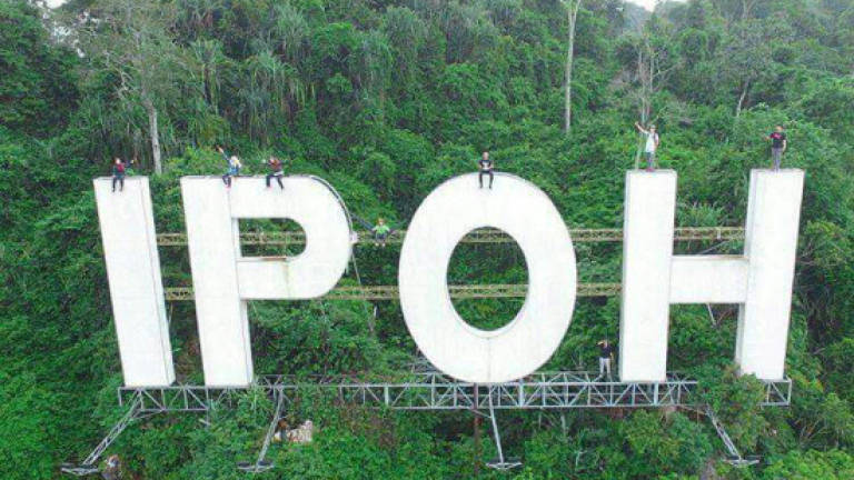 Another man climbs Ipoh signboard