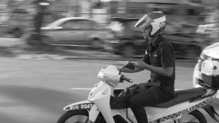 IGP: Action to be taken against cop pictured using phone while riding