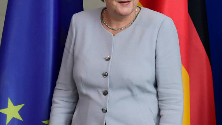 Weakened Merkel scrambles to form government