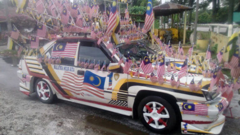 Villagers decorate cars in the spirit of patriotism