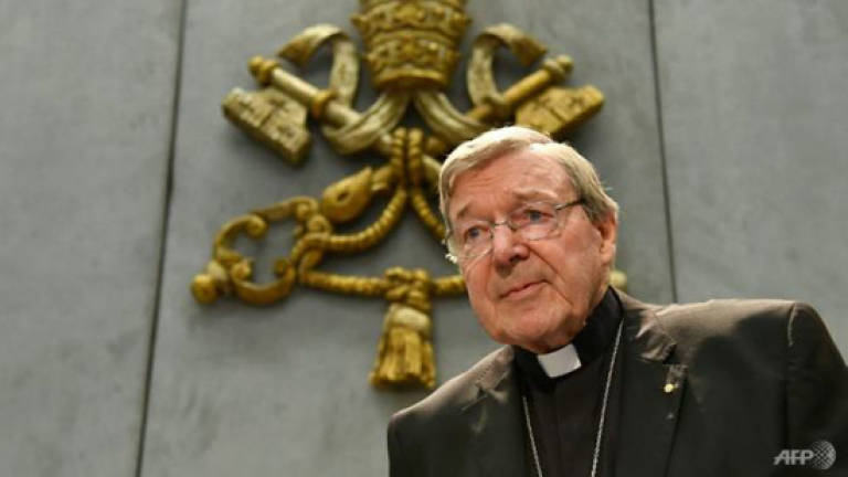 Cardinal Pell back in Australia to face abuse charges