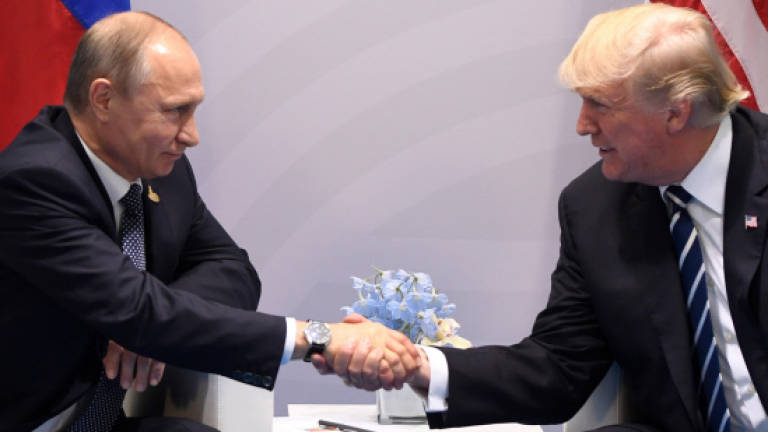 Russian media cheer over Trump and Putin handshake