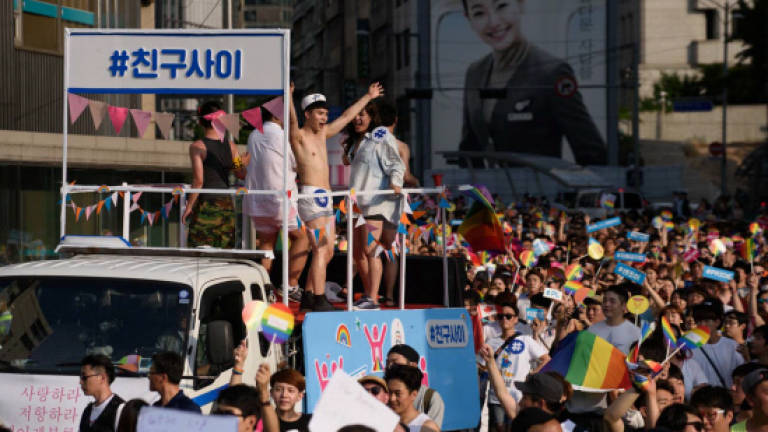 Gay rights supporters parade amid rain, protests in Seoul