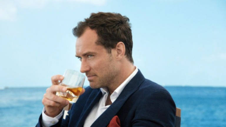 Jude Law dances in his latest role as spokesman for whiskey