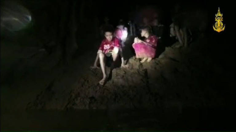 'Race against water' as rain threatens Thai boys in the cave