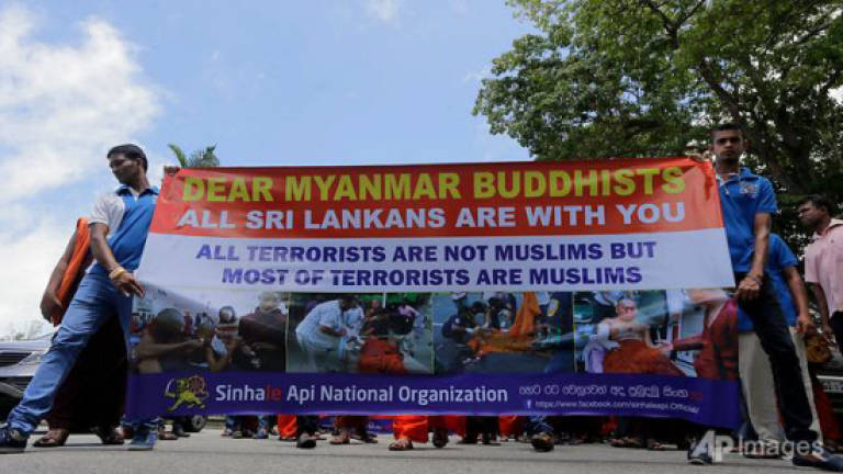 Sri Lanka arrests six in hunt for monks who attacked refugees