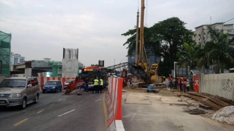Fallen crane nearly crushes bus and 2 other vehicles